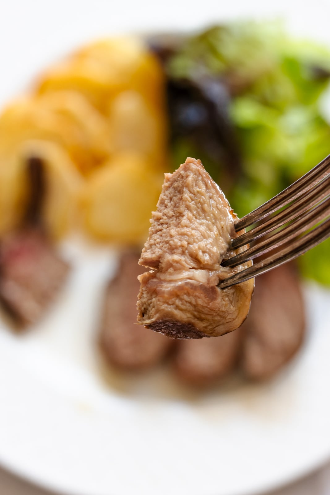 Close up of the lamb on a fork.