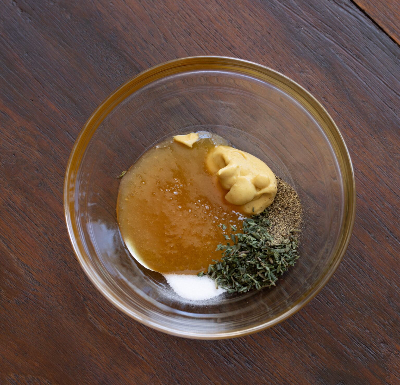 Honey, mustard, thyme, salt and pepper in a small bowl.