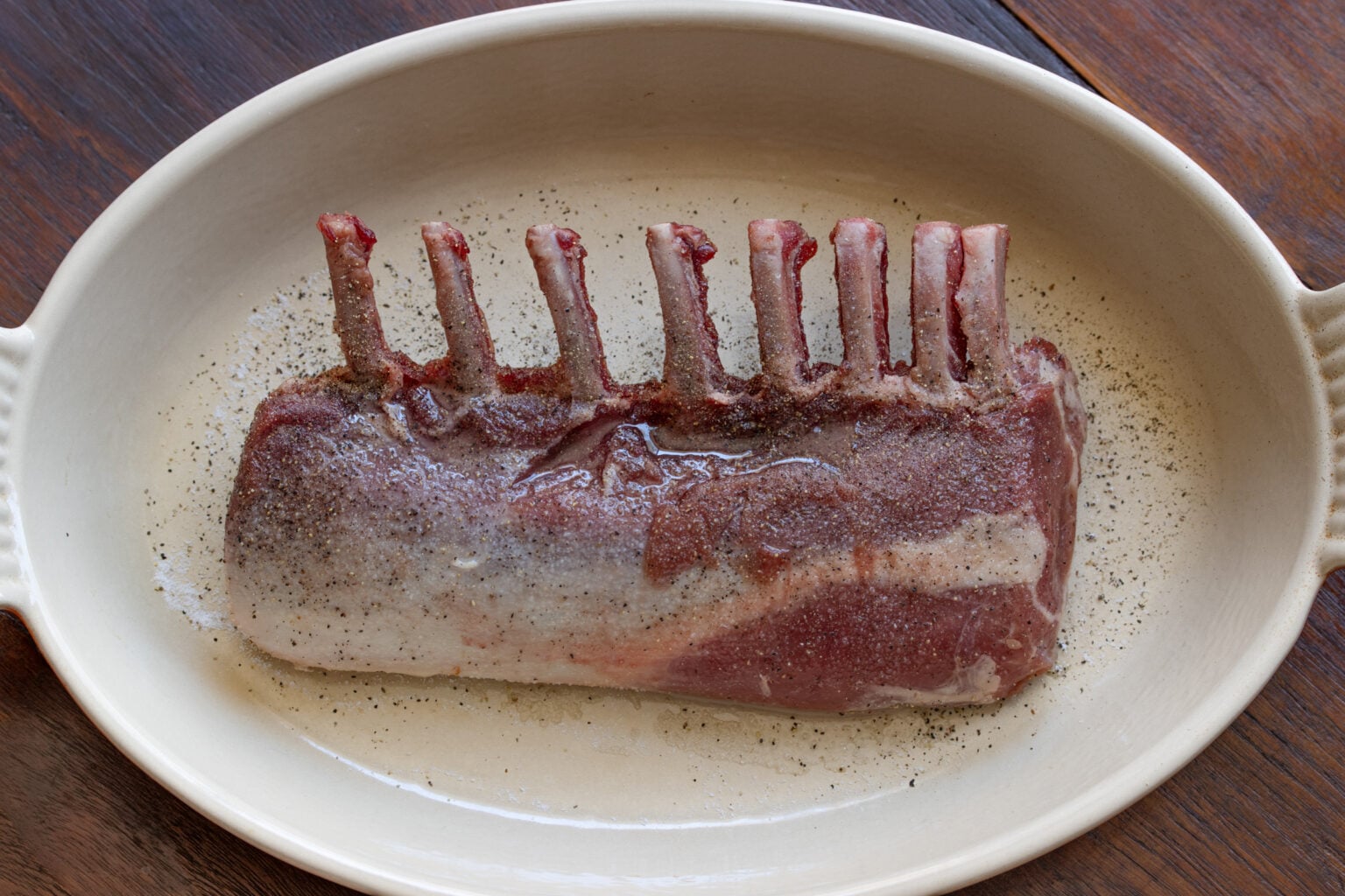 Rack of lamb brushed with olive oil and seasoned generously with salt and pepper.