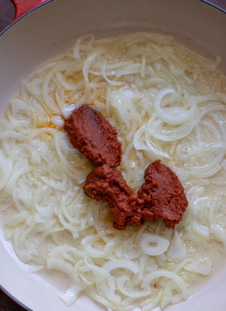 Curry paste added to the translucent onions.