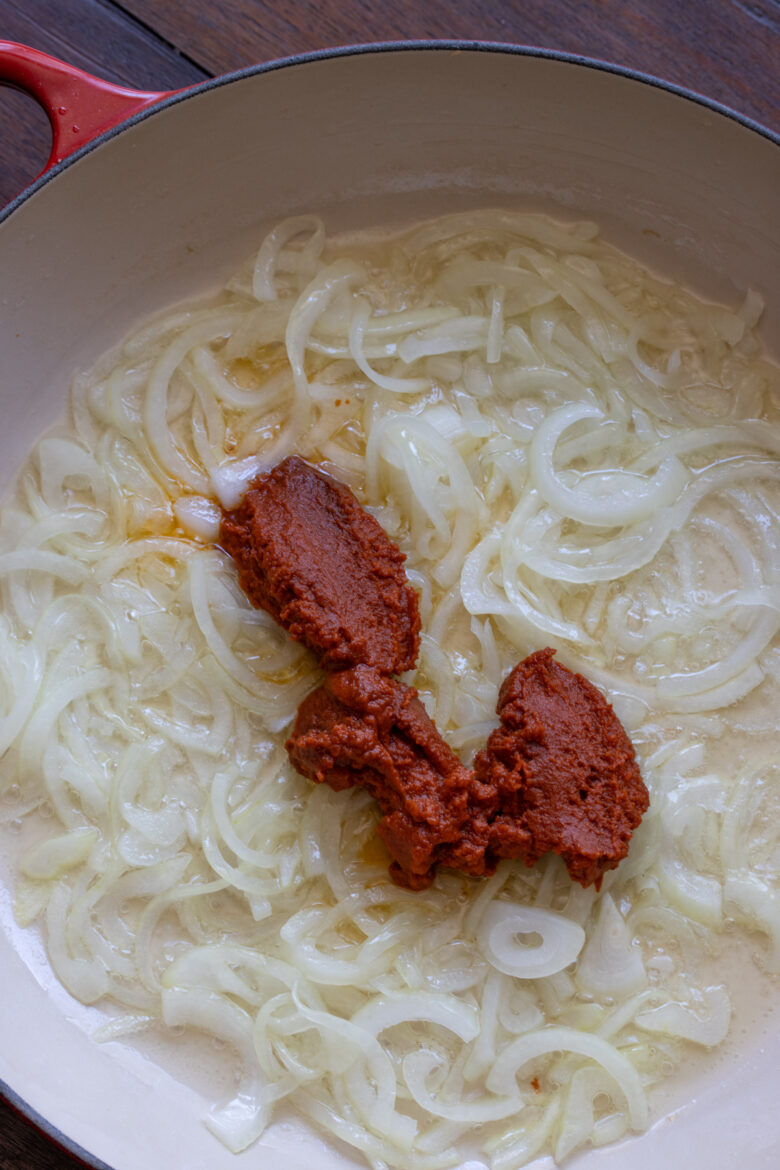 Curry paste added to the translucent onions.