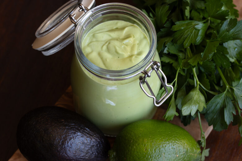 Avocado dressing placed in a glass container.