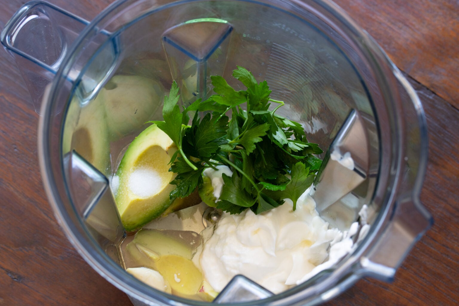 All the ingredients are placed in a blender to create the creamy avocado dressing.