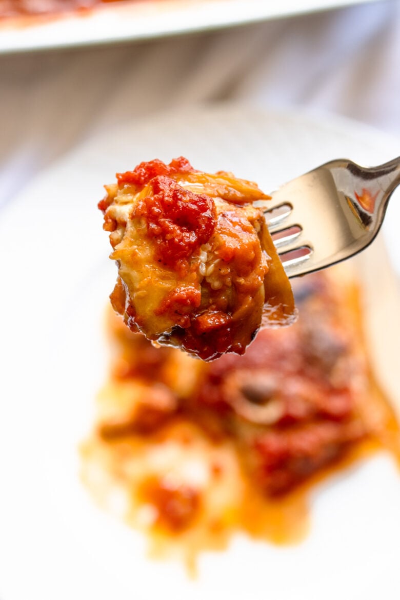 A close up look at the parmigiana on a fork