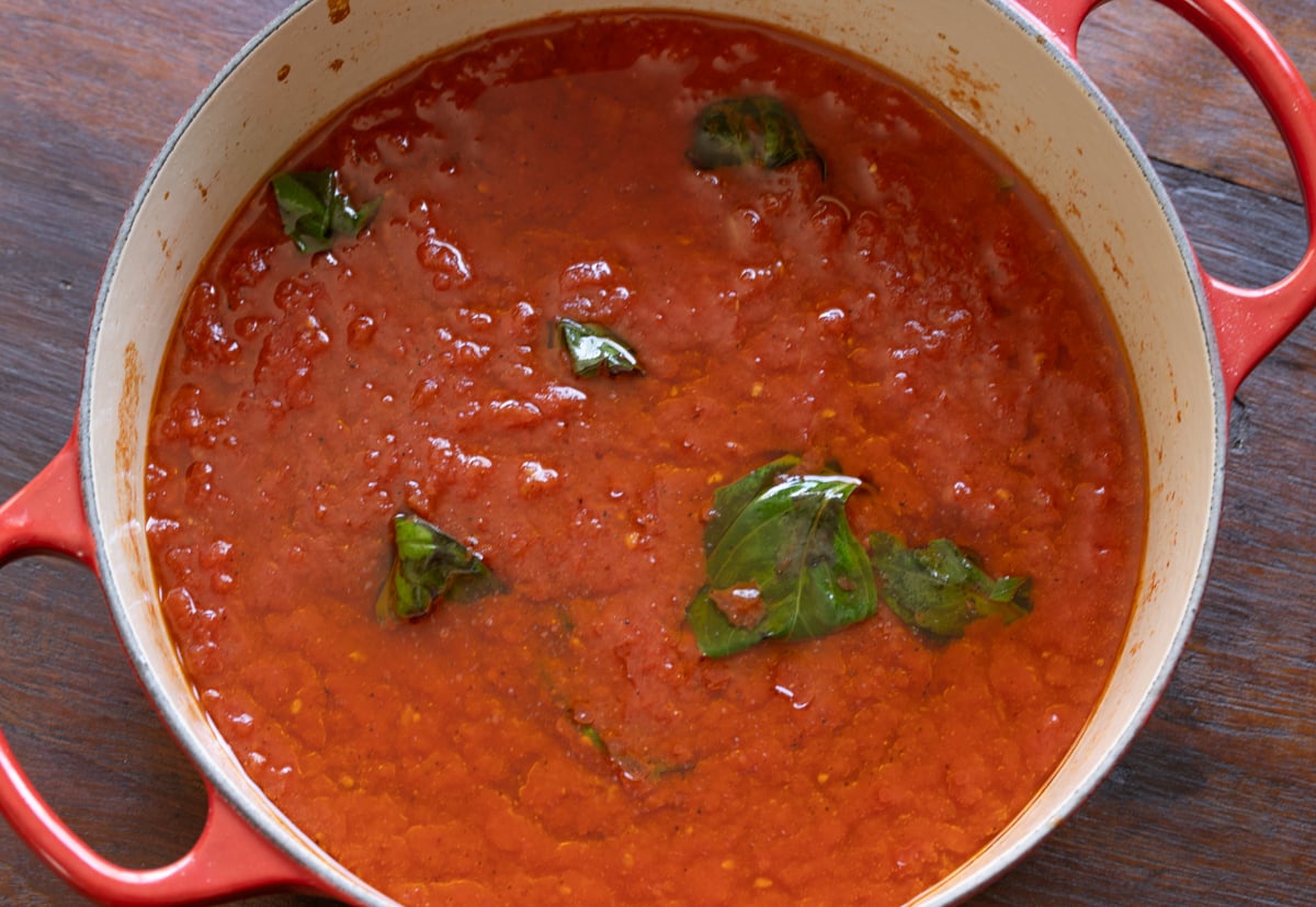 Tomato sauce added to the garlic with the basil.
